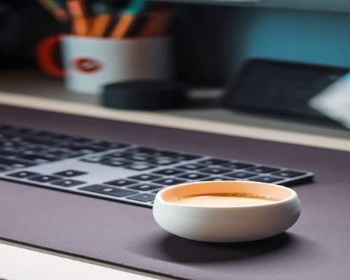 Cozy workspace layout with fresh coffee cup and clean dynamic lighting setup