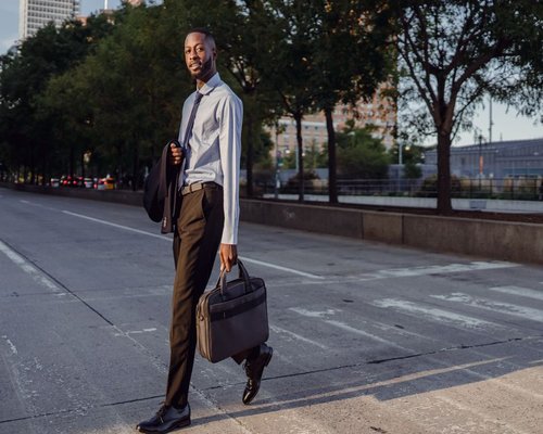Active professional enjoying a morning walk near a vibrant city park dynamic